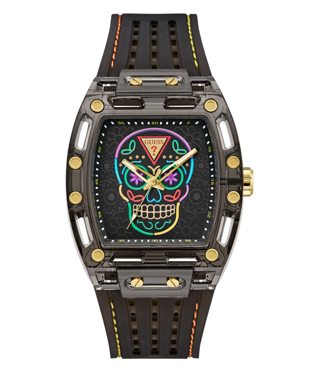 A GUESS wristwatch with a dark gray and black case, a colorful neon sugar skull face graphic, and a perforated black rubber strap with yellow and orange stitching.