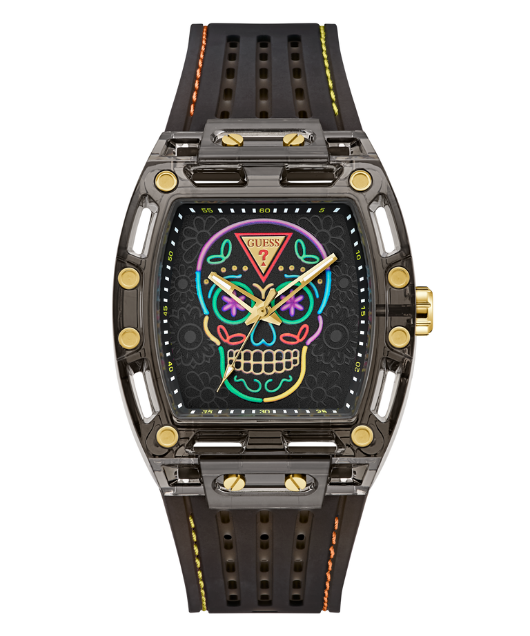 A GUESS wristwatch with a dark gray and black case, a colorful neon sugar skull face graphic, and a perforated black rubber strap with yellow and orange stitching.