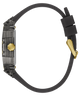 A side profile view of a watch with a transparent case, black silicone strap, and gold-tone accents, including a gold crown button and a gold clasp.