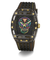 A luxury wristwatch with a black carbon fiber case, a black textured strap with yellow stitching, and a colorful Day of the Dead sugar skull dial. The watch features gold-tone screws and hands, and is photographed on a clean white background with a soft shadow.