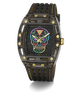 A luxury wristwatch with a black carbon fiber case, a black textured strap with yellow stitching, and a colorful Day of the Dead sugar skull dial. The watch features gold-tone screws and hands, and is photographed on a clean white background with a soft shadow.