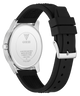 The back of a GUESS watch with a silver stainless steel case and a black textured silicone strap, shown on a white background.