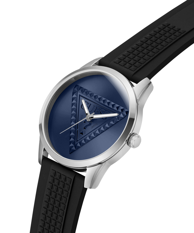 A luxury watch with a silver-tone stainless steel case, a textured dark blue dial featuring a geometric triangle pattern, and a black textured silicone strap, shown on a solid white background. lifestyle