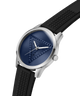 A luxury watch with a silver-tone stainless steel case, a textured dark blue dial featuring a geometric triangle pattern, and a black textured silicone strap, shown on a solid white background. lifestyle