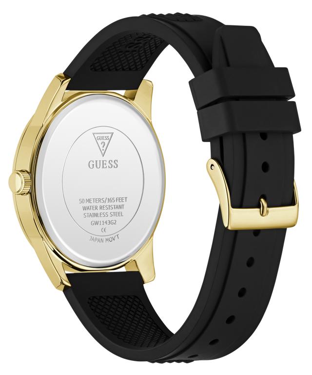The back of a GUESS watch with a gold-tone case and a black textured silicone strap, shown on a clean white background.