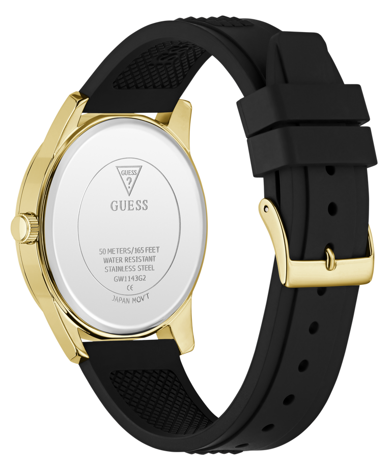 The back of a GUESS watch with a gold-tone case and a black textured silicone strap, shown on a clean white background.