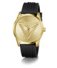 A Guess women's analog watch featuring a gold-tone round case, a gold-tone dial with an embossed triangle logo, and a textured black silicone strap.