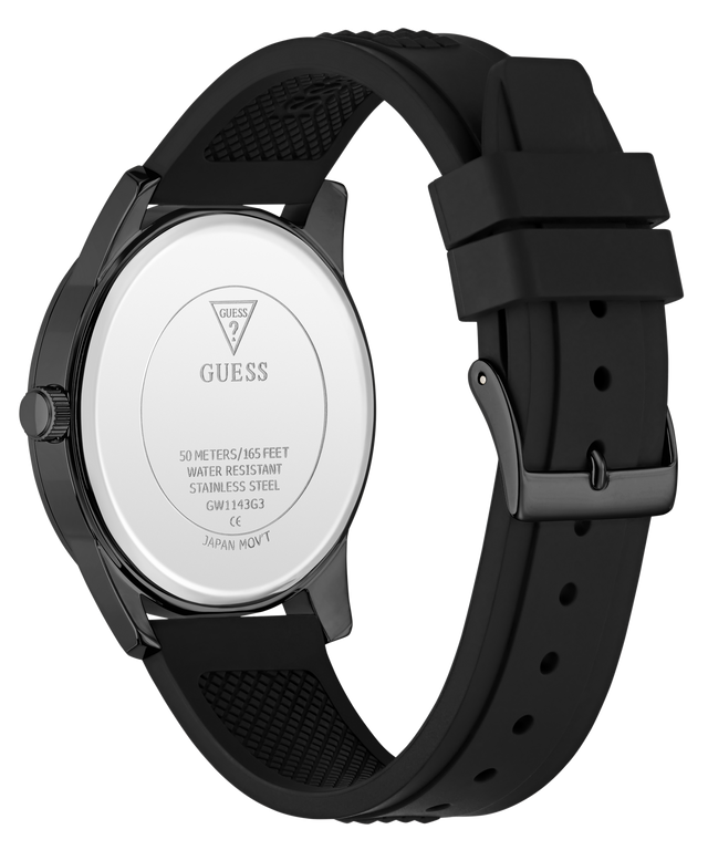 The back view of a GUESS watch with a black silicone strap and a dark gunmetal case, showing the silver-toned stainless steel case back with the GUESS logo.