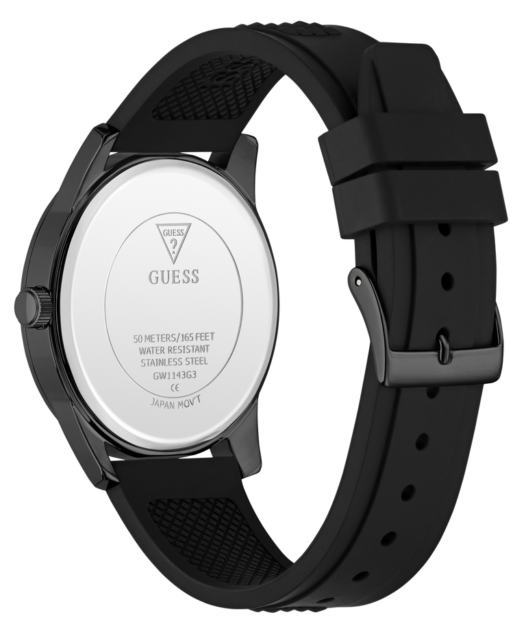 The back view of a GUESS watch with a black silicone strap and a dark gunmetal case, showing the silver-toned stainless steel case back with the GUESS logo.