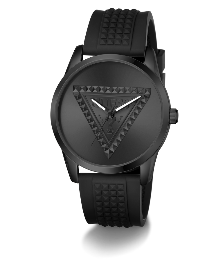 A black Guess wristwatch with a textured triangular logo on the dial and a matching black silicone strap with a pyramid pattern, shown against a plain white background.