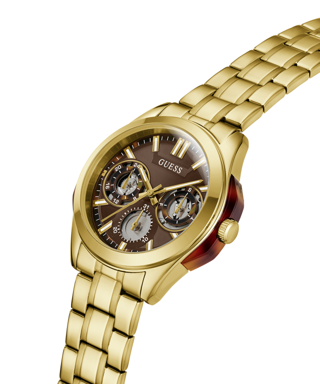 Gold-tone Guess wristwatch with a multi-dial brown dial and matching gold-tone metal link bracelet, shown on a clean white background. lifestyle