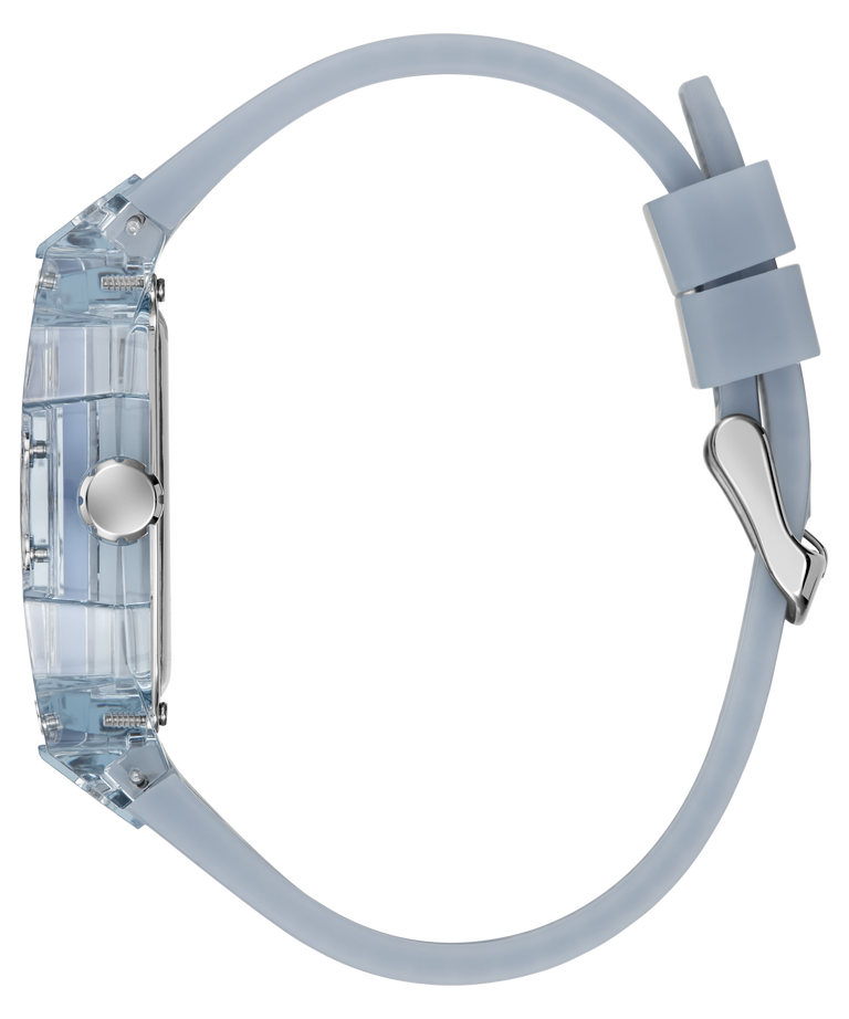 A side profile view of a GUESS watch with a translucent light blue case and a matching light blue silicone strap, featuring a silver-tone buckle and crown.