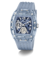 A Guess wristwatch with a translucent light blue case and matching strap, featuring a blue and black marbled dial with silver-tone details.