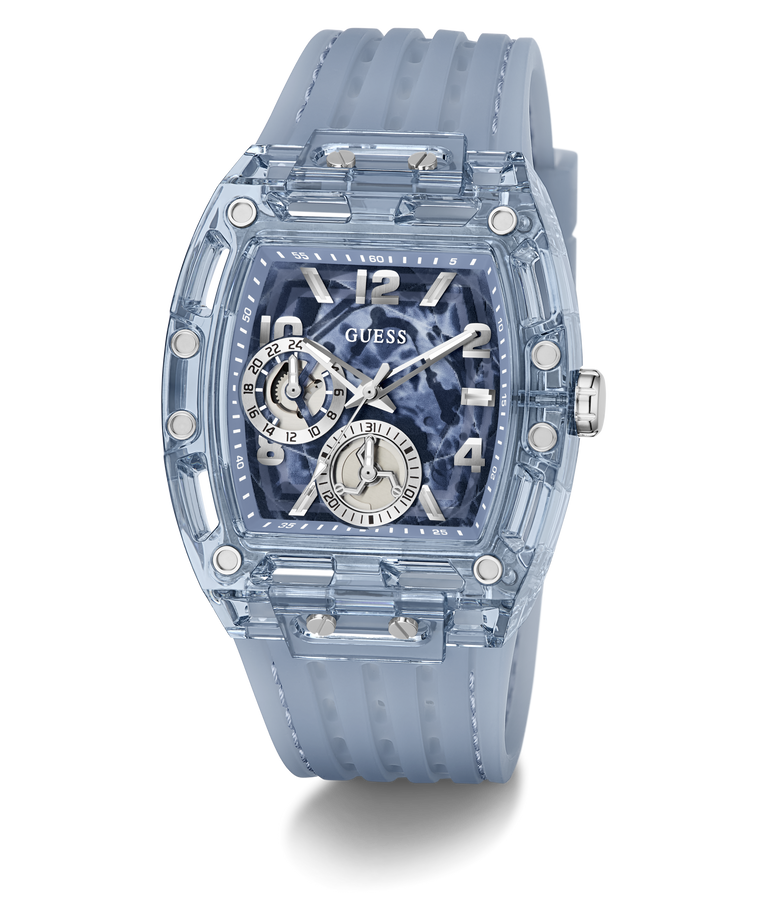 A Guess wristwatch with a translucent light blue case and matching strap, featuring a blue and black marbled dial with silver-tone details.