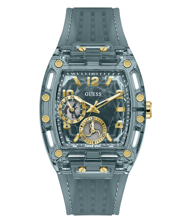 A GUESS wristwatch with a translucent smoky gray case and matching textured strap, featuring gold-tone accents, gold Arabic numerals, and two smaller subdials on a white background.