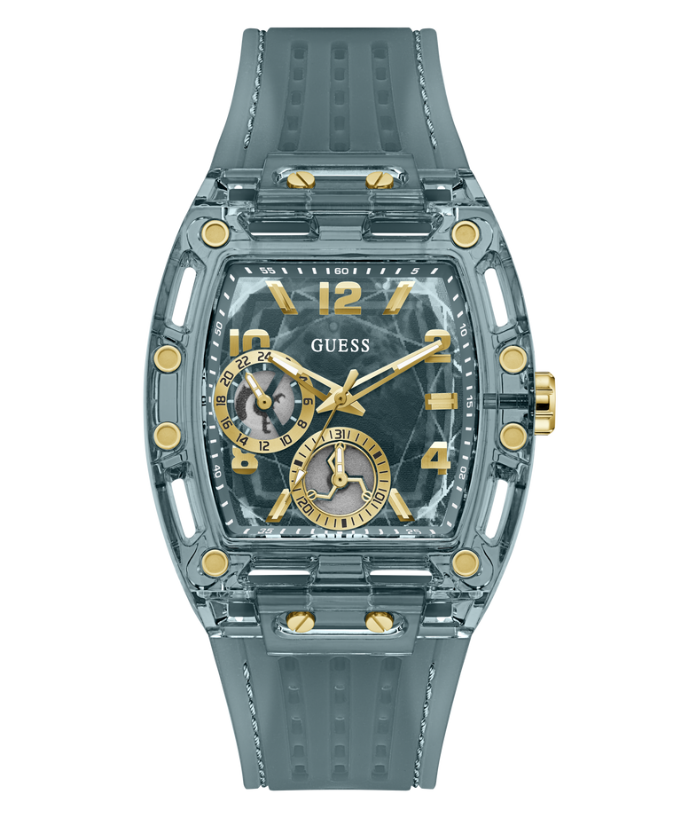 A GUESS wristwatch with a translucent smoky gray case and matching textured strap, featuring gold-tone accents, gold Arabic numerals, and two smaller subdials on a white background.