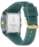 A GUESS watch shown from the back, featuring a translucent smoky gray case, a silver stainless steel back plate with brand text, and a muted teal silicone strap with a gold-tone buckle.