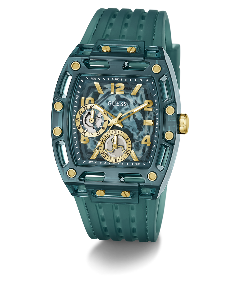 A GUESS wristwatch with a translucent teal-green case and matching textured strap, featuring gold-tone accents, a patterned dial, and two subdials.