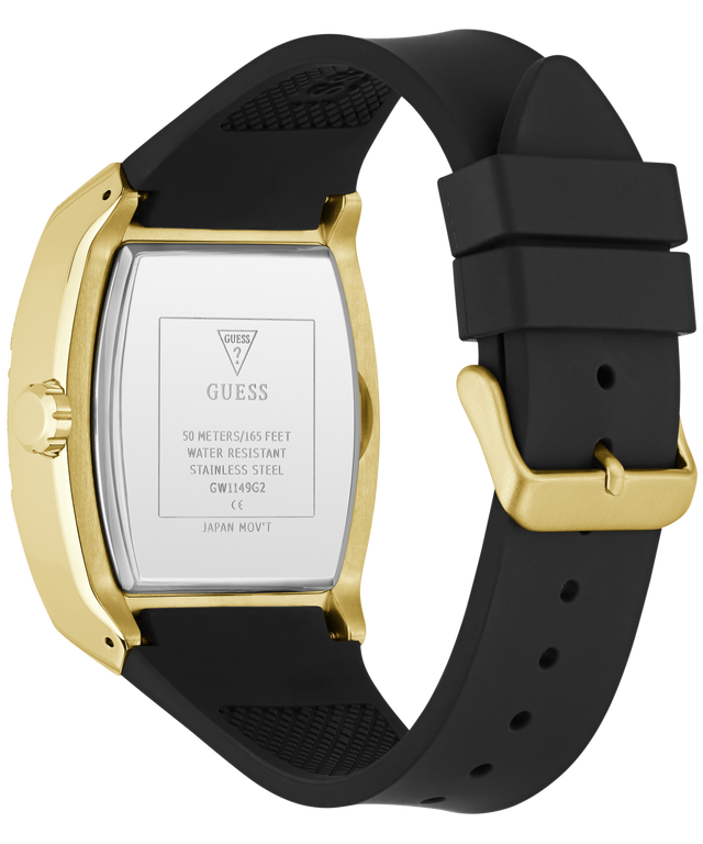 The back view of a GUESS watch with a gold-tone case and a black silicone strap, showing the stainless steel case back with printed specifications.