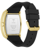 The back view of a GUESS watch with a gold-tone case and a black silicone strap, showing the stainless steel case back with printed specifications.