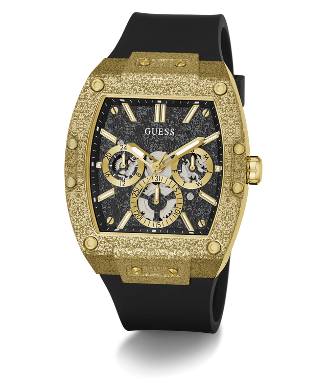 A luxury wristwatch by Guess featuring a textured gold-tone case, a black dial with three subdials, and a black rubber strap, shown on a clean white background.