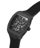 A GUESS men's watch featuring a rugged, textured black case and a matching black strap, with a detailed skeleton-style dial and Roman numeral hour markers, shown on a plain white background. lifestyle