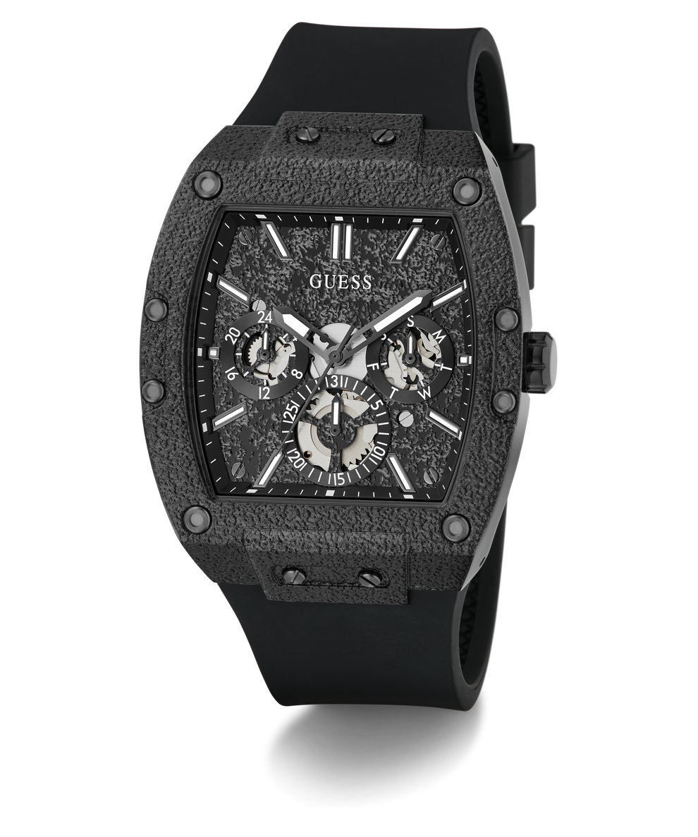 A GUESS chronograph watch with a textured dark gray and black case, a black dial with silver-tone subdials, and a black rubber strap, shown on a white background with a soft shadow.
