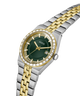 A GUESS men's watch featuring a two-tone silver and gold stainless steel link bracelet, a dark green dial, and a bezel accented with clear crystals. lifestyle