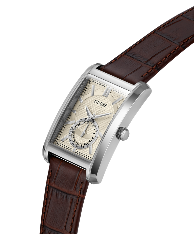 A Guess men's wristwatch with a silver-tone rectangular case, a cream-colored dial with a small sub-dial, and a brown alligator-pattern leather strap, shown on a plain white background. lifestyle