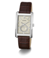 A GUESS men's analog watch featuring a silver-tone rectangular case, a cream-colored dial with a small sub-dial, and a dark brown leather strap with a crocodile-embossed texture.
