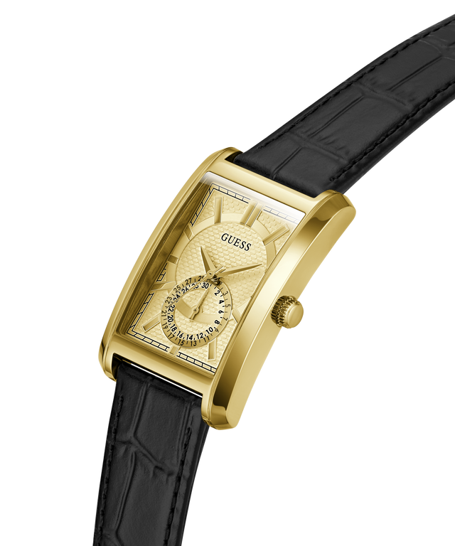 A GUESS men's rectangular analog watch with a gold-tone case, textured gold dial, and a black alligator-embossed leather strap, shown on a clean white background. lifestyle