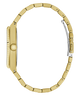 A gold-tone watch shown from the side profile, featuring a matching metal link bracelet, a textured crown guard, and a silver-toned clasp on a plain white background.