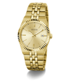 Gold-tone Guess wristwatch with a matching metal link bracelet, gold dial, fluted bezel, and a date window at 3 o'clock, shown on a clean white background.
