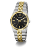 A Guess men's analog watch with a two-tone silver and gold stainless steel bracelet, a fluted gold bezel, and a black dial with gold hands and a date window.
