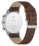 The back view of a GUESS watch with a brown leather strap and a silver stainless steel case, showing the branded backplate.
