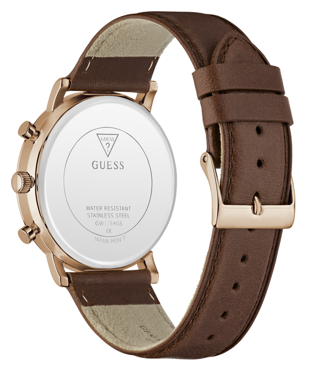 The back of a GUESS watch with a brown leather strap and a rose gold case, showing the branded white back plate and buckle.