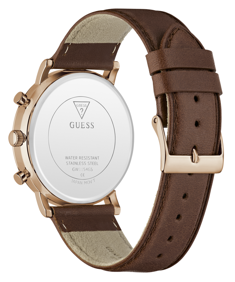 The back of a GUESS watch with a brown leather strap and a rose gold case, showing the branded white back plate and buckle.