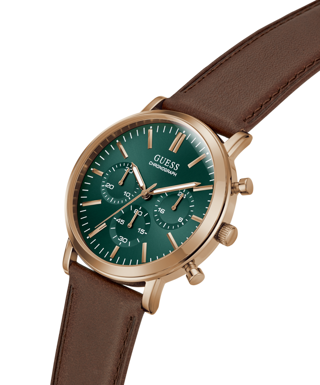 A Guess chronograph watch with a green dial and rose gold case, paired with a brown leather strap, shown on a clean white background. lifestyle