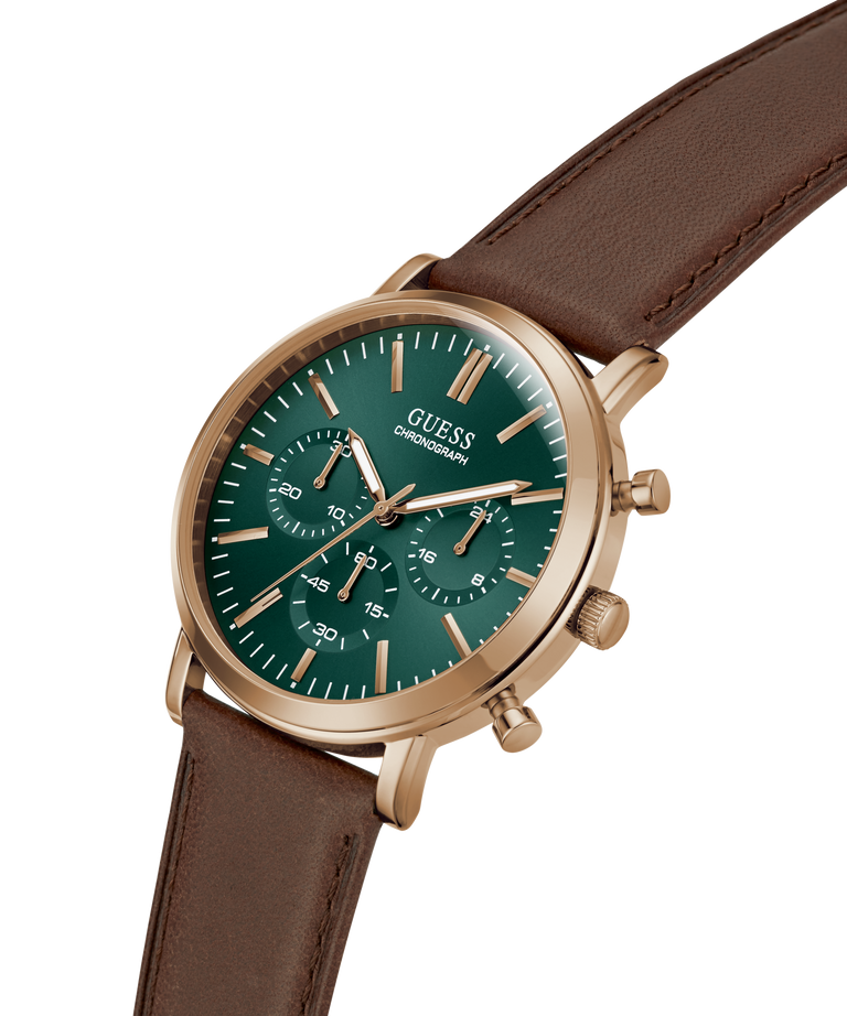 A Guess chronograph watch with a green dial and rose gold case, paired with a brown leather strap, shown on a clean white background. lifestyle