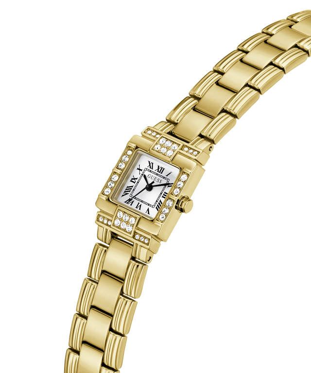 A gold-tone women's watch with a rectangular bezel set with small clear stones, a white dial with black Roman numerals, and a matching gold-tone link bracelet, shown on a plain white background. lifestyle