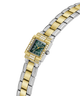 A two-tone watch with a gold and silver link bracelet, a green dial, and a bezel accented with small clear crystals, shown on a plain white background. lifestyle