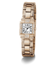 A GUESS watch with a rose gold-tone metal bracelet and case, featuring a white dial with black Roman numerals and diamond accents, shown on a clean white background.