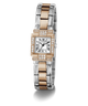 A GUESS watch with a two-tone silver and rose gold bangle bracelet, a silver rectangular dial with black Roman numerals, and a bezel set with clear crystals, shown on a white background.