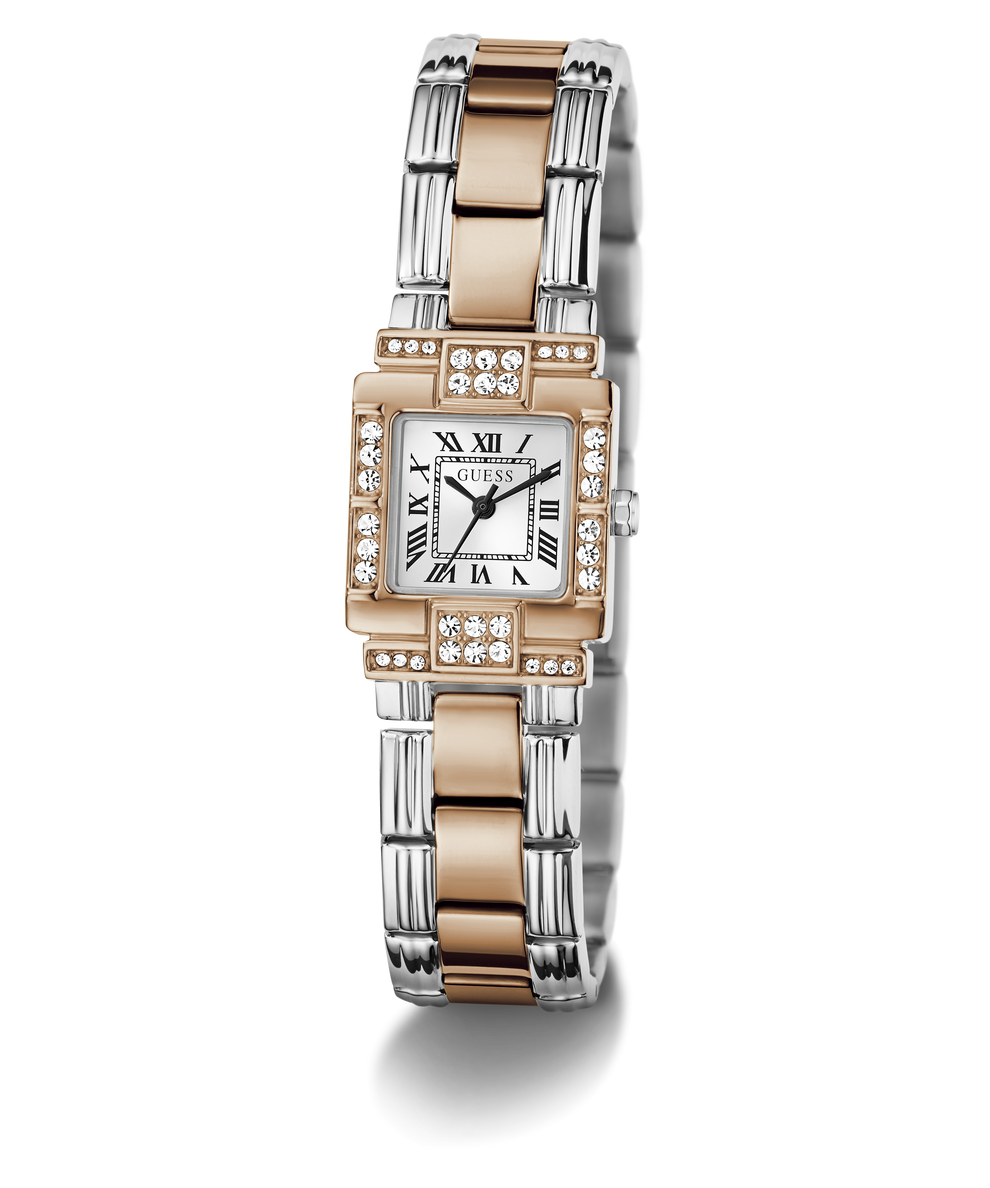 A GUESS watch with a two-tone silver and rose gold bangle bracelet, a silver rectangular dial with black Roman numerals, and a bezel set with clear crystals, shown on a white background.