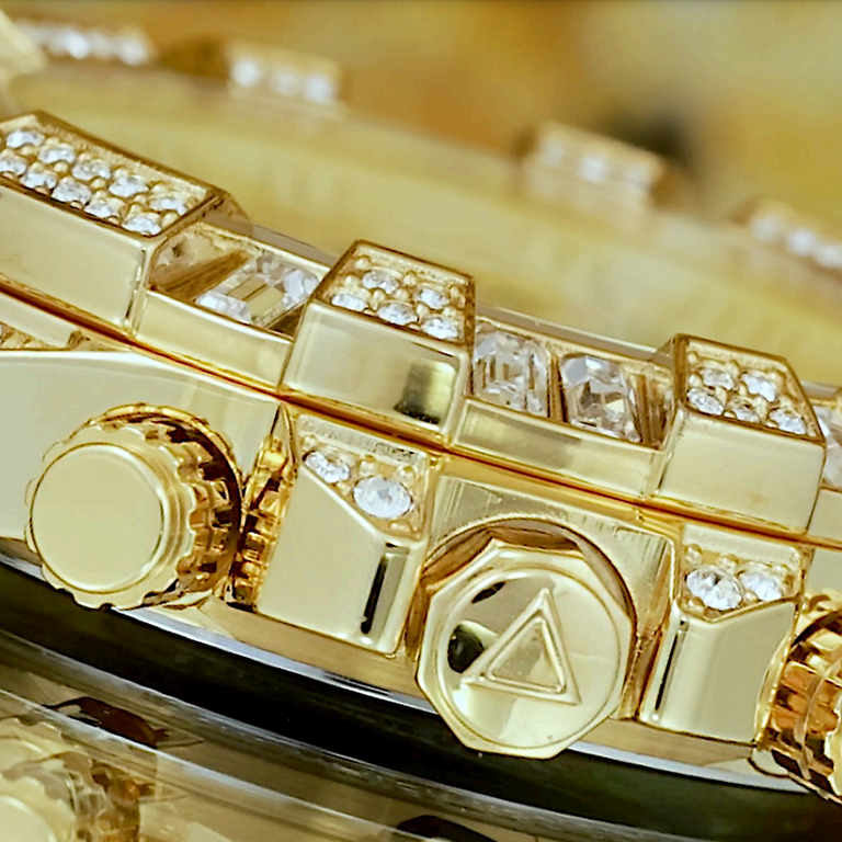 close up of mens gold watch with stones