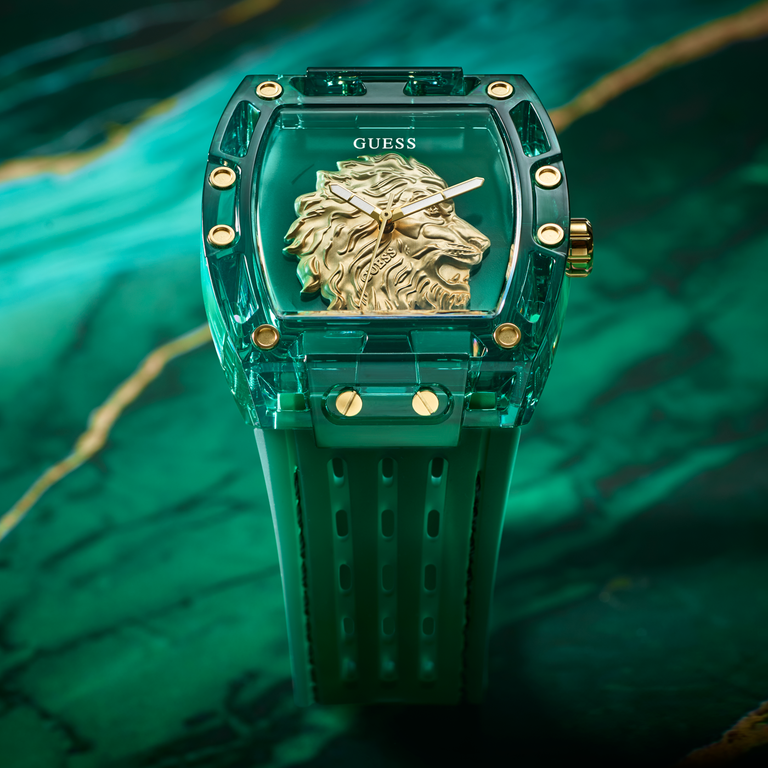 Green watch with gold lion emblem on a green marble background