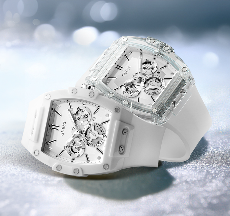 White Guess watches with transparent case on a reflective surface