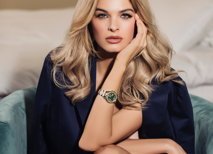 woman wearing gold Gc watch with green dial