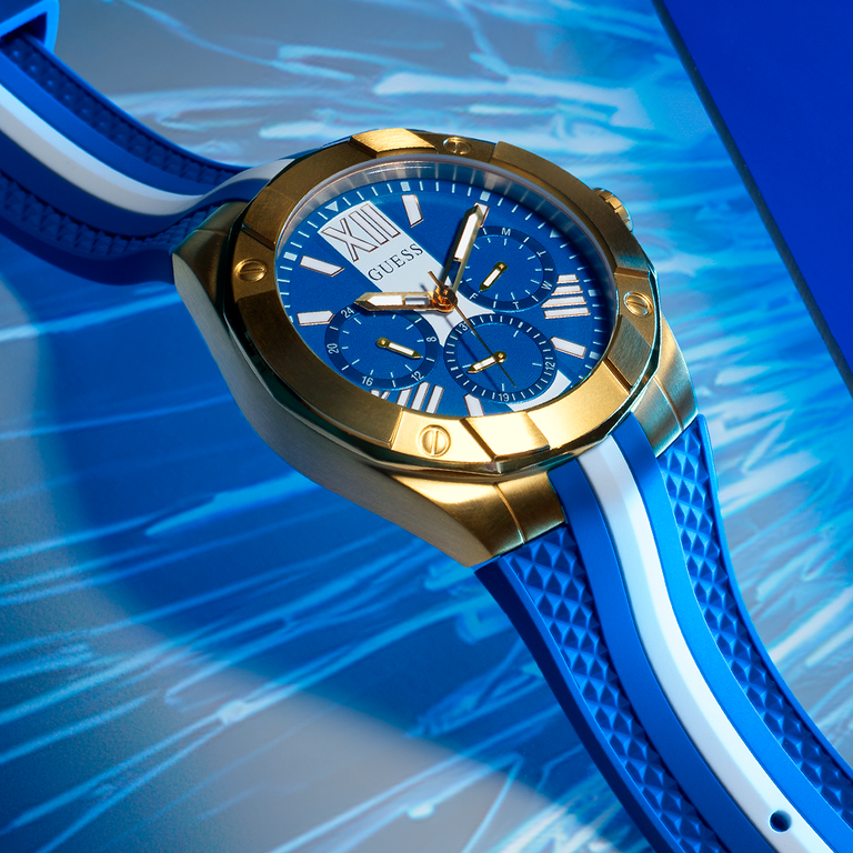 mens blue watch with white strap on dial and gold case