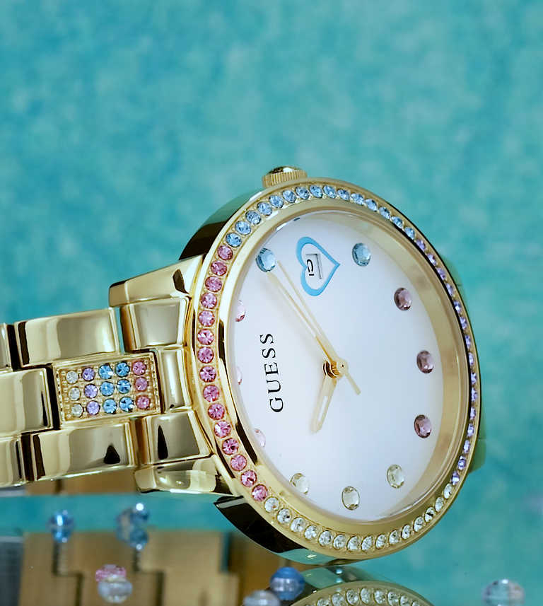 gold watch with hearts and gems on dial